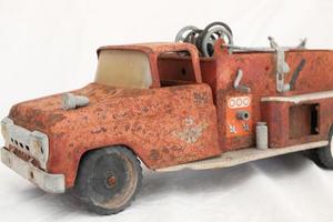 Early 1960s Vintage Red Number 5 Fire truck that has rusted out and seen better days photo