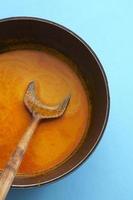 Indian red curry in iron pan photo