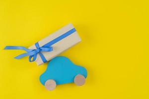 caja de regalo con carro de juguete mesa amarilla foto