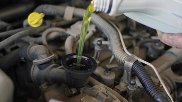 Car Repair Master Pouring New Oil To Engine Footage video