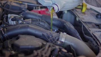Car perair Master Pouring New Oil To Engine Footage