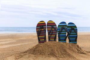 Flip flops on the sandy beach photo