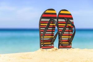 Flip flops on the sandy beach photo