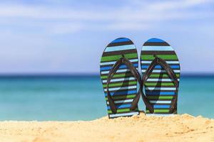 Flip flops on the sandy beach photo