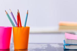 Pencils and book on table photo