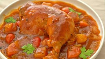 homemade chicken stew with tomatoes, onions, carrot and potatoes on plate video