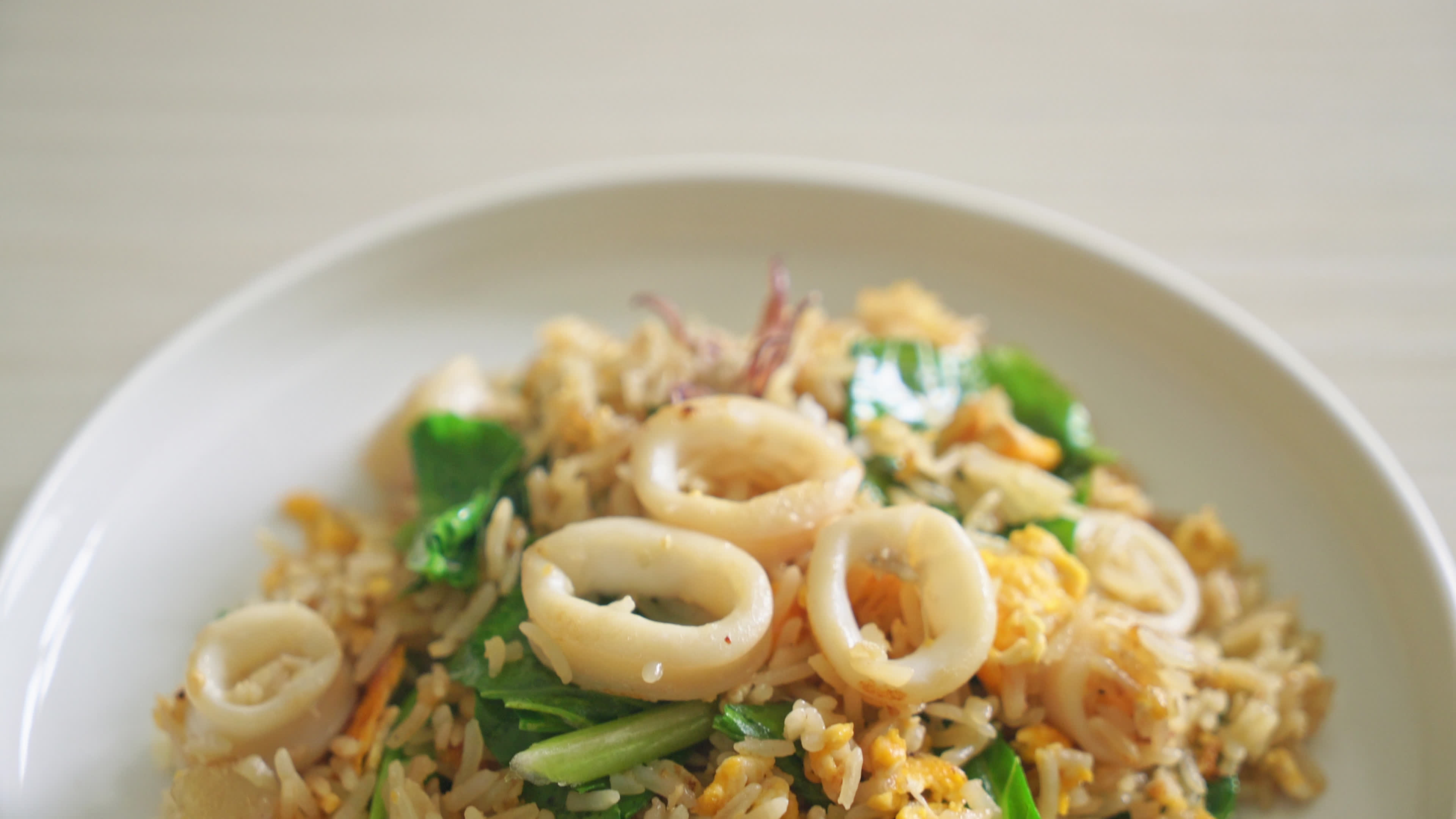Fried rice with squid or octopus in bowl - stir-fried rice with squid