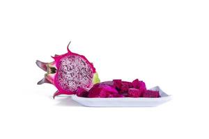 dragon fruit cut into small pieces served on a white plate isolated on a white background. photo