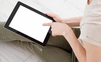 woman using tablet and touching blank display at home, hand device photo