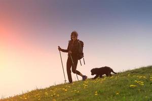 Girl walks in the mountains with his dog photo