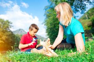 Naturopath practicing reflexology at the foot of a child photo