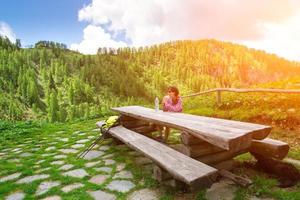 Girl eats a sandwich during a mountain walk photo