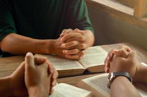 Christians join a group of cells that come together to pray and seek the blessings of God. with bible and share the gospel with copy space near the window sill in the morning photo