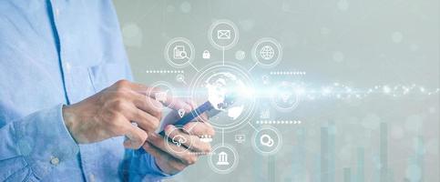 Business man using a mobile smartphone and browsing for information on network connection icon with customer growth graph Digital Marketing, Banking, Online Payments business analysis and planning photo