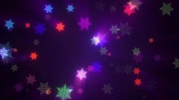 Beautiful colorful neon snowflakes on dark background. video