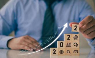 2022 Successful Business Development and Growing Growth Ideas business analysis and financial concepts with statistical graph Place wooden blocks, icons and numbers 2022. photo