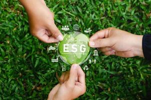 Global ESG icon concept with teamwork. Contribute to saving the environment in a heart shape and in a sustainable business on networking on a green background. photo