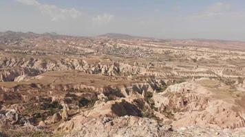4k stock video of cloudy sky over volcanic mountains in Cappadocia, Anatolia, Goreme in Turkey country. Hiking destination - Rose valley. Aerial view at cloudscape panorama over horizon