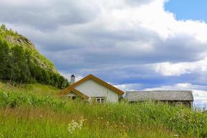 White cottage on a mountain in a meadow, Hemsedal, Norway. photo