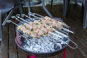 Russian shashlik with skewers on a round grill. photo