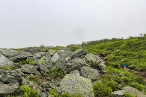 Hiking trail between rocks cliffs on Veslehodn Veslehorn mountain, Norway.. photo