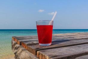 Strawberry juice on table wood photo