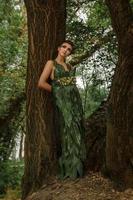 girl in a dress of green palm leaves photo