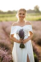 the bride in a white dress  on the lavender field photo