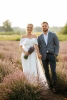 bride and groom on in the lavender field photo