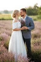bride and groom on in the lavender field photo