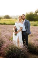 bride and groom on in the lavender field photo