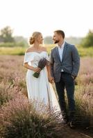 bride and groom on in the lavender field photo