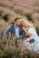 bride and groom on in the lavender field photo