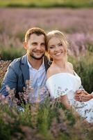 bride and groom on in the lavender field photo