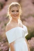 the bride in a white dress  on the lavender field photo