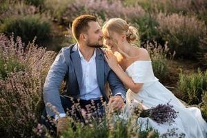 bride and groom on in the lavender field photo