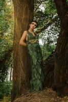 girl in a dress of green palm leaves photo