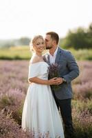 bride and groom on in the lavender field photo