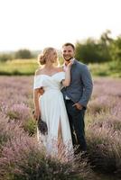 bride and groom on in the lavender field photo