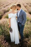 bride and groom on in the lavender field photo