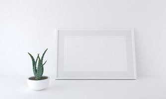 Representación 3D de una maqueta de marco en blanco junto a una planta en maceta apoyada contra una pared blanca foto