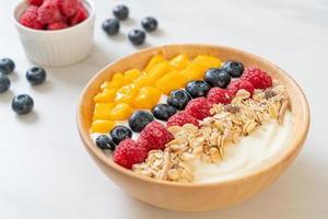 homemade yogurt bowl with raspberry, blueberry, mango and granola photo