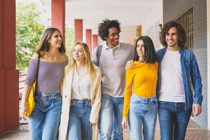 Multi-ethnic group of students walking together on the street. photo