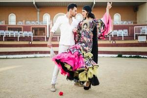 Couple, models of fashion, in a bullring photo