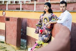 Couple, models of fashion, in a bullring photo