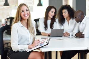 Multi-ethnic group of three businesspeople meeting in a modern office. photo