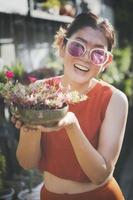 happiness woman raising portulaca flower plant pot