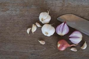 Onion and garlic for cooking on old wooden background photo
