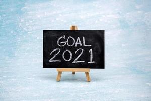 The message GOAL 2021 is written in white chalk on a black chalk board. photo