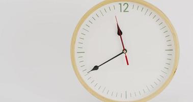 Close up, In five minutes it will be noon. It's time for lunch. Wall clock on the white background. video